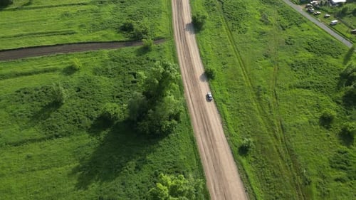 Aerial View Revealing Verdant Farmland Rural Road Winding Through Agricultural Landscape Sunlight