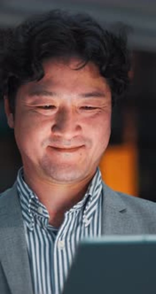 Happy, night and Asian man on tablet in city for communication, typing email and networking