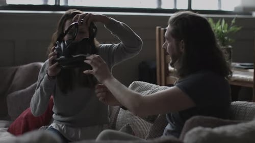 Couple Using Virtual Reality Headset on Living Room Couch
