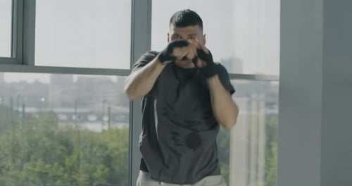 Man Practicing Boxing Moves in Urban Gym