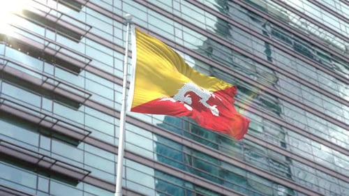 Bhutan Flag Waving in Wind Against Modern Corporate Building