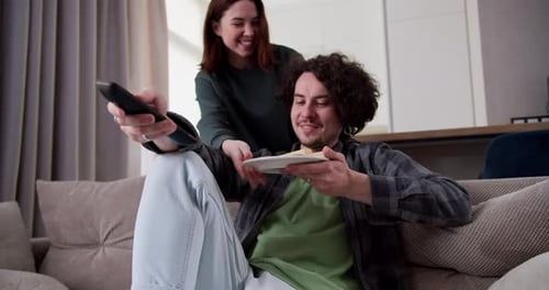 Couple Relaxing and Watching TV at Home