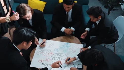 Diverse Business Team Brainstorming Mind Map in Office