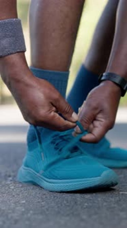 Person, hands and tying with shoes for workout preparation, fitness or running safety on road