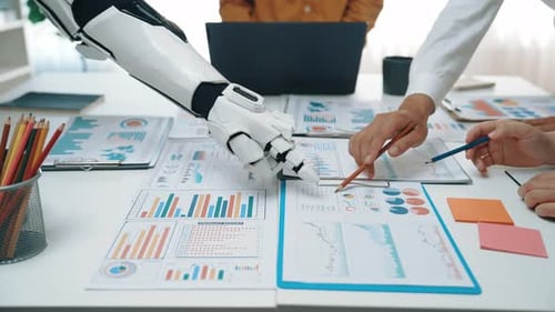 Robot and People Analyze Charts Together at Workplace