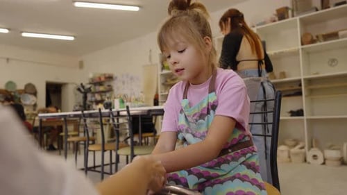 Young Artist Creates Pottery in a Cheerful Workshop with Colorful Decorations