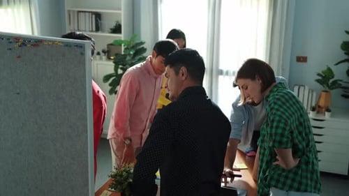 Creative team choosing idea from sticky notes and stick at board. Convocation.