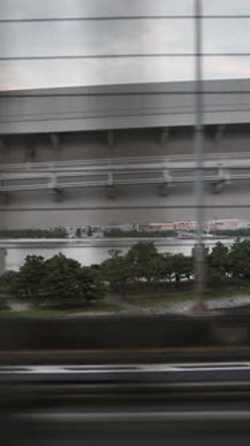 Tokyo Monorail Passing Through the City's Skyscapers in Vertical