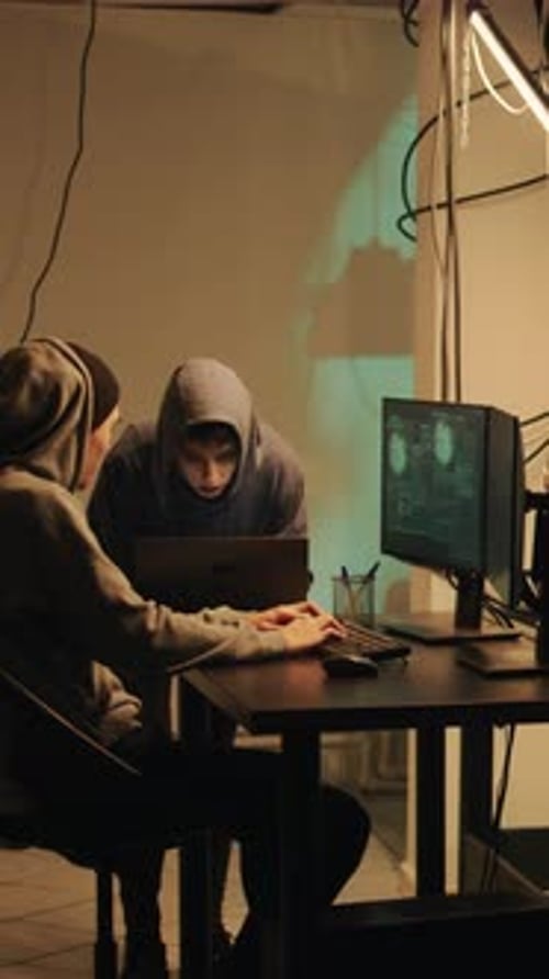 Young Adults Working on Computer in Dimly Lit Room