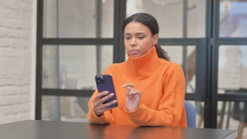 Casual African Woman Talking on phone in Office