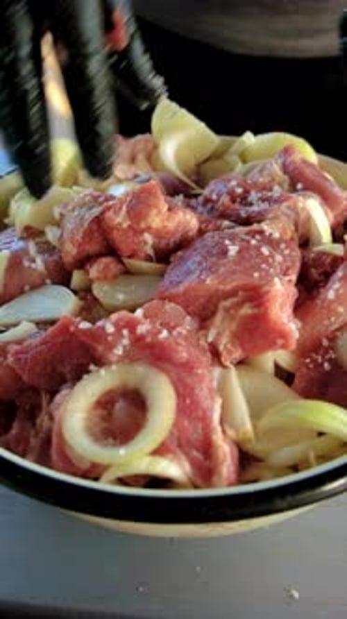 Preparing Meat with Onions and Salt for Cooking