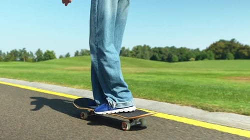 Skillful Stylish Teenage Girl Skateboarder Skateboarding in Summer Park