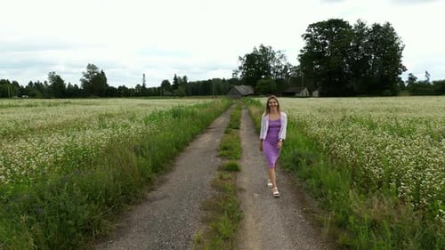 Floral Escape Woman Walking Through a White Flower Field Surrounded By the Serenity of Nature and