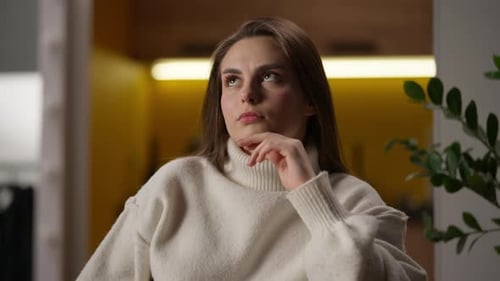 Thoughtful Woman with Hand on Chin Indoors