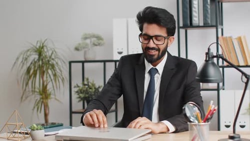 Indian Business Man Freelancer at Office Start Working on Laptop Computer Sends Online Messages