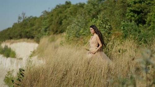 Elegant Woman Standing in Rural Grassy Field