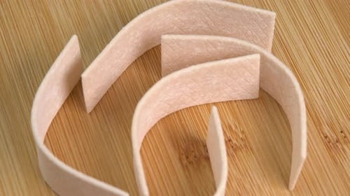 Chewing gum plates, mint chewing gum close-up rotate on a wooden background