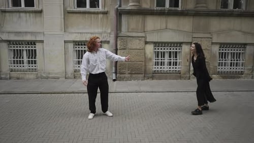A Joyful Couple Dances on a Lively Street Showcasing Love and Connection