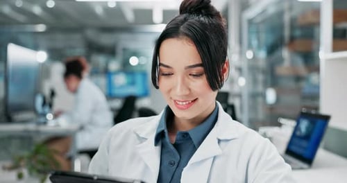 Woman Scientist Using Tablet in Modern Laboratory