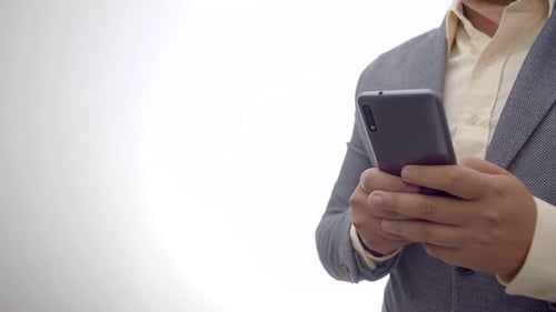 corporate communication concept. businessman using a smartphone on a white background