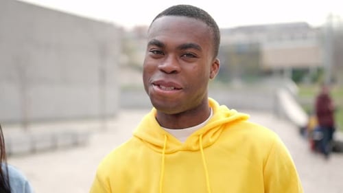 Smiling Man in Yellow Hoodie Looking at Camera