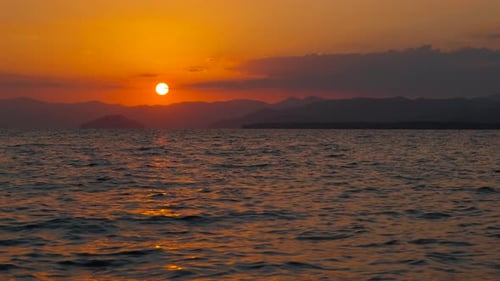 Sunset Path on Dark Lake Waves