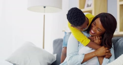 Affectionate Mother and Child Hug on Sofa