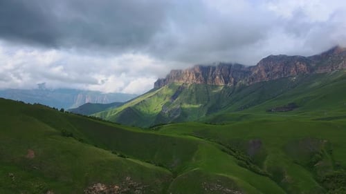 Lush Green Mountains Under Cloudy Sky Aerial View
