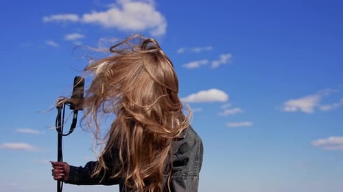 Young Woman Singing Into Microphone Outdoors