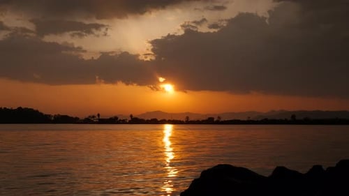 River Silhouette Under Orange Dusk