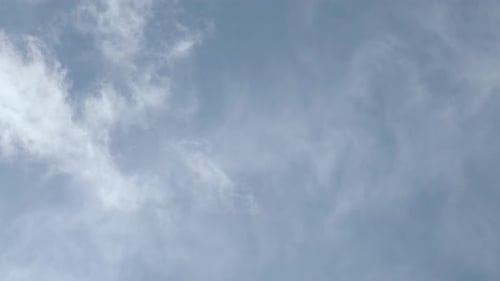 Clouds drifting across blue sky