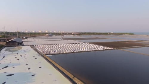Aerial capture of workers harvesting salt in Petchburi, Thailand