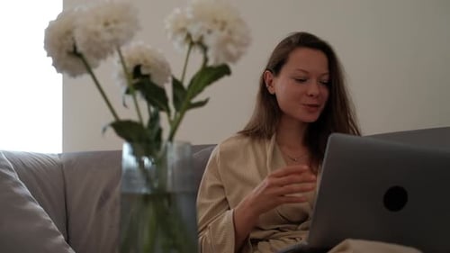 Woman on Video Call at Home with Laptop