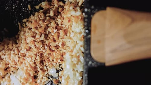 Frying Diced Onions and Crushed Nuts in Pan