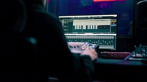 Close Up in the Recording Room Dark with Neon Lighting in the Studio the Sound Engineer Works at the