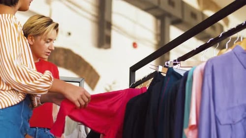 Two women shopping together at clothing store