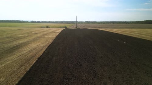 Tractors plowing the field in Ukraine