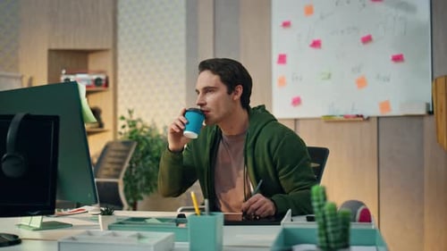 Relaxed Designer Working Computer in Home Office. Closeup Calm Professional Creator Drinking