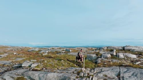 Man Accompanied by a Dog Navigating the Terrain Close to Rissa and Hasselvika in Blaheia Mountain in