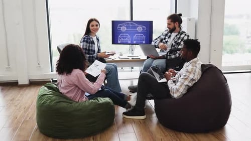 Team Brainstorming Automotive Design in Creative Workspace with Professionals