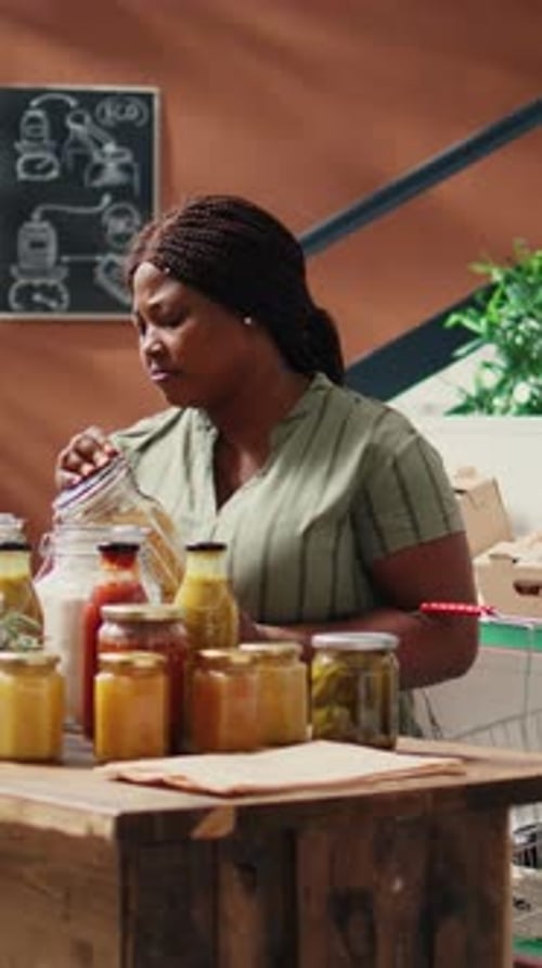 Young Adult Checking Preserved Food Jars