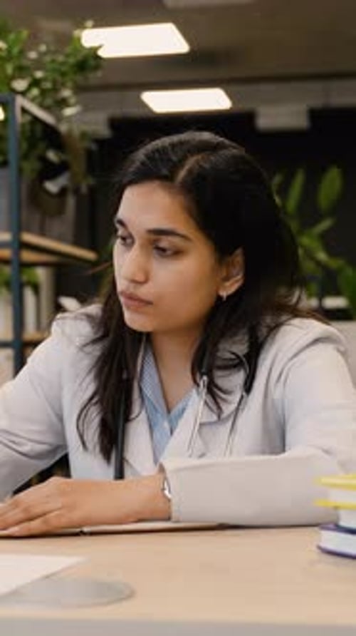 Young Female Indian Doctor Studying Online with Laptop