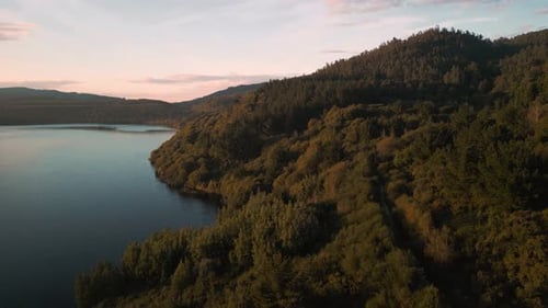 Forested Mountain With Coastal Road In Lago das Encrobas, A Coruna Spain. Aerial Drone Shot