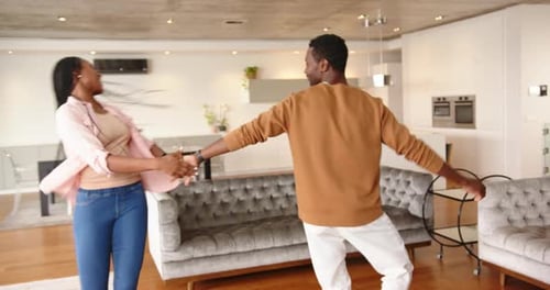 Smiling Couple Dancing in Modern Living Room