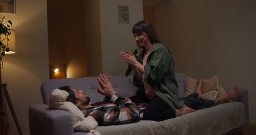 Man and Woman Laughing and Playing Patty Cake at Home