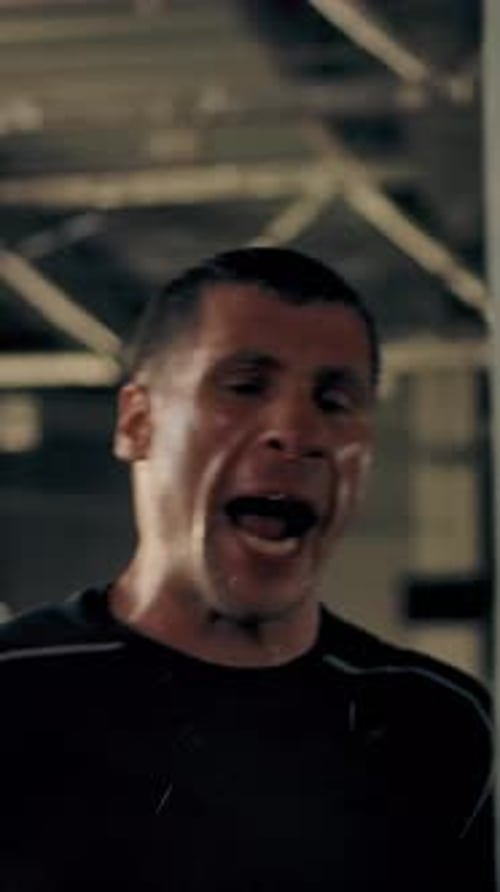 Man Punching Padded Surface with Boxing Gloves