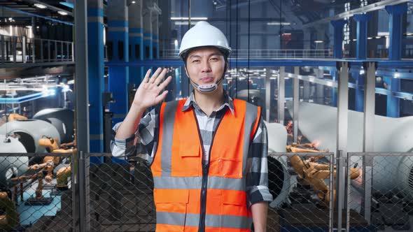 Asian Male Engineer Smiling And Waving Hand Saying Good Bye In Factory ...