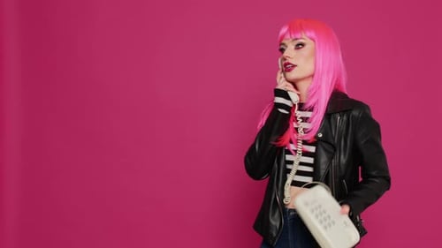 Happy Confident Model with Pink Hair Talking on Landline Phone Call