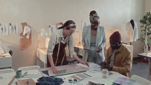 Studio Colleagues Discussing and Creating Design of New Clothes