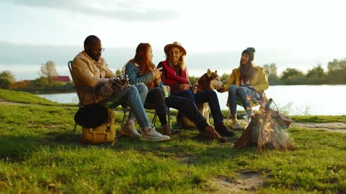 Friends Relaxing by Campfire with Dog